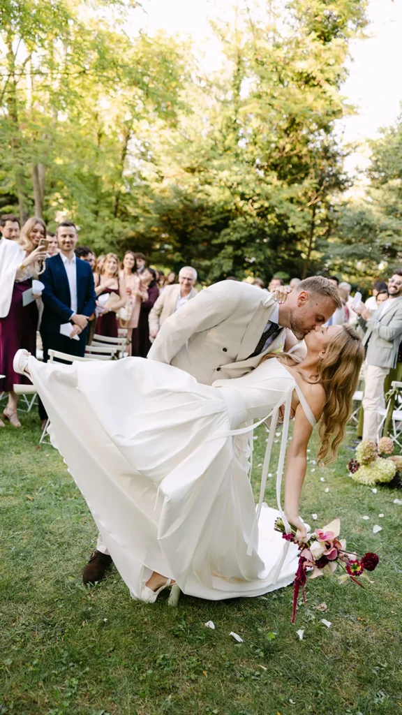 Couple sharing a romantic wedding kiss.