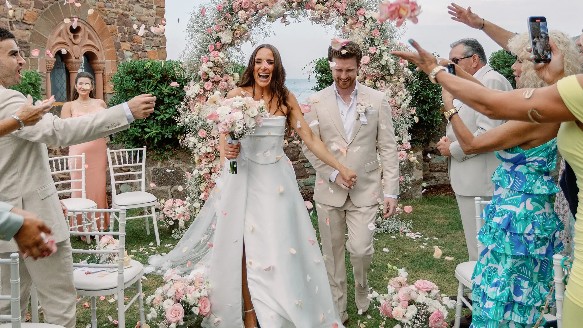 Couple celebrating wedding with guests.